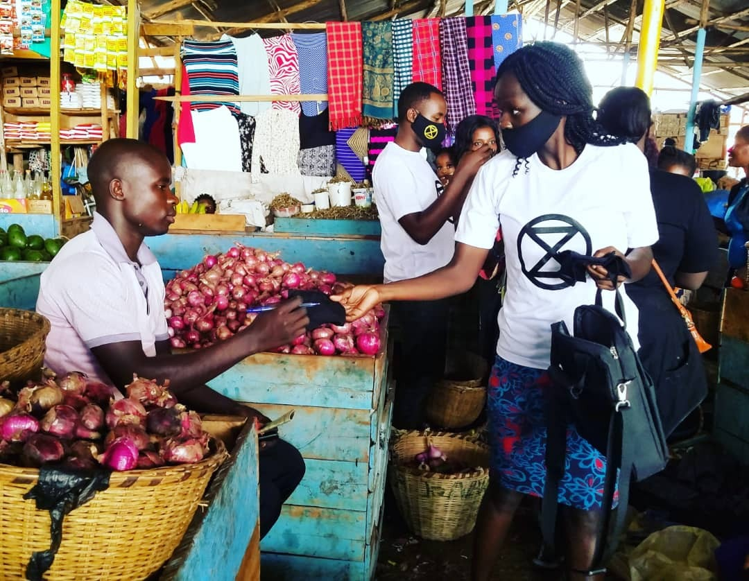 Rebels in Kampala
hand out face masks and soap to market vendors.